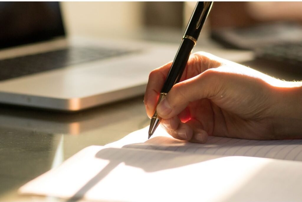 person keeping budget notes simple to avoid financial burnout