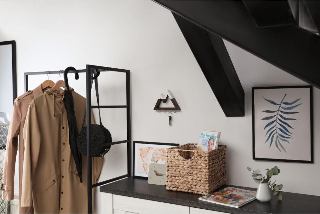 organized wooden entryway coat rack with keys in ceramic bowl