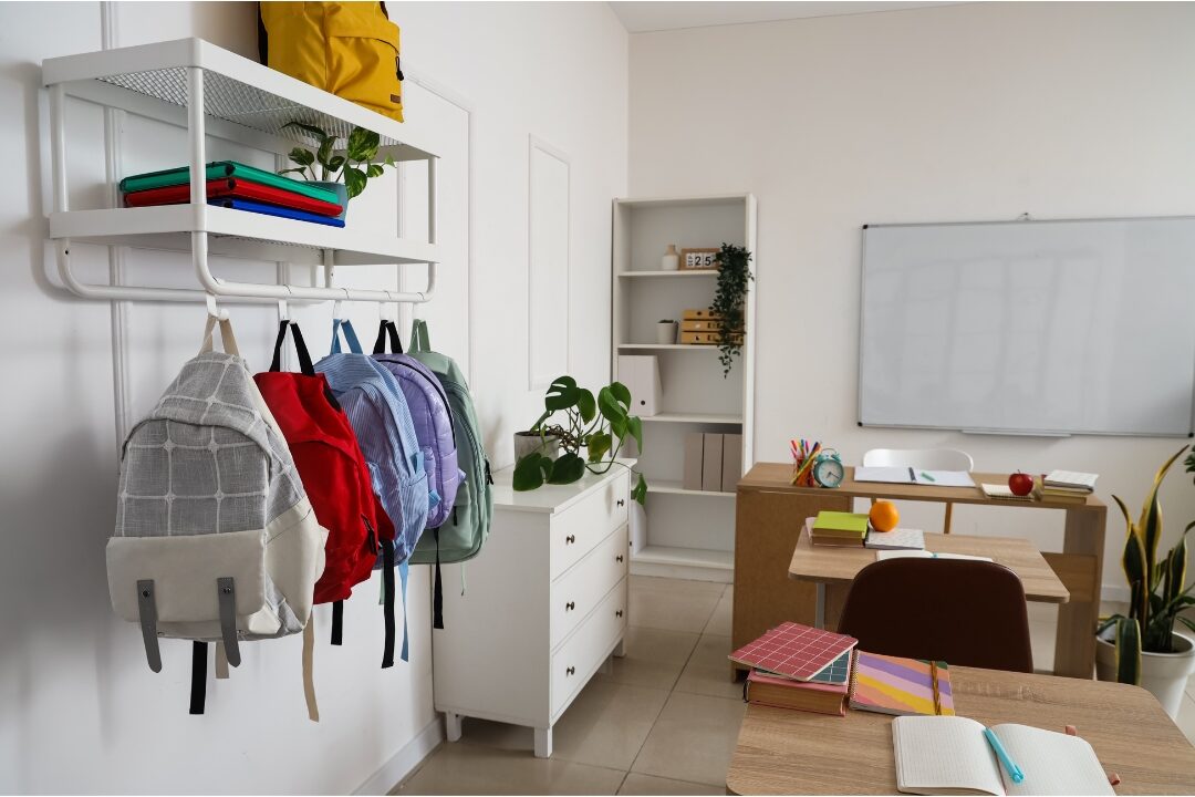 organized wooden entryway bench with neat school backpacks hanging on hooks managing morning exit