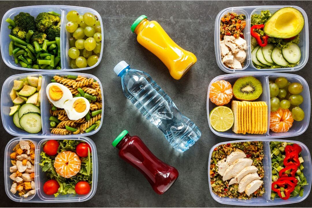 glass meal prep containers filled with chopped vegetables and fruit