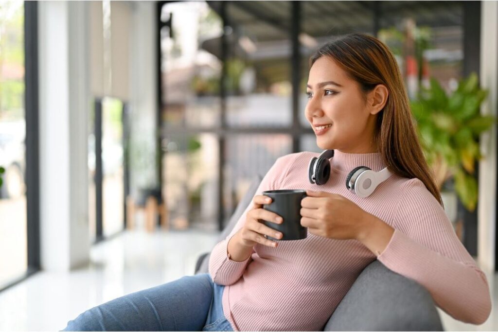 woman looking out window calmly protecting her peace from unsolicited advice