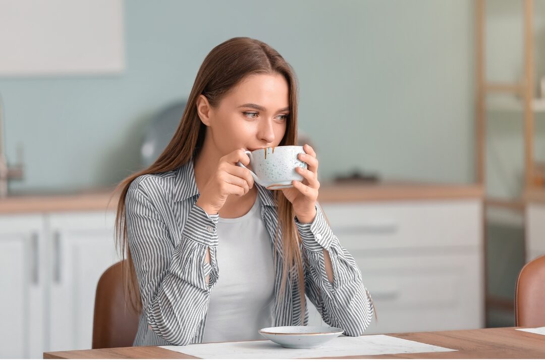 woman sitting calmly at clean kitchen counter holding warm mug setting healthy household boundaries