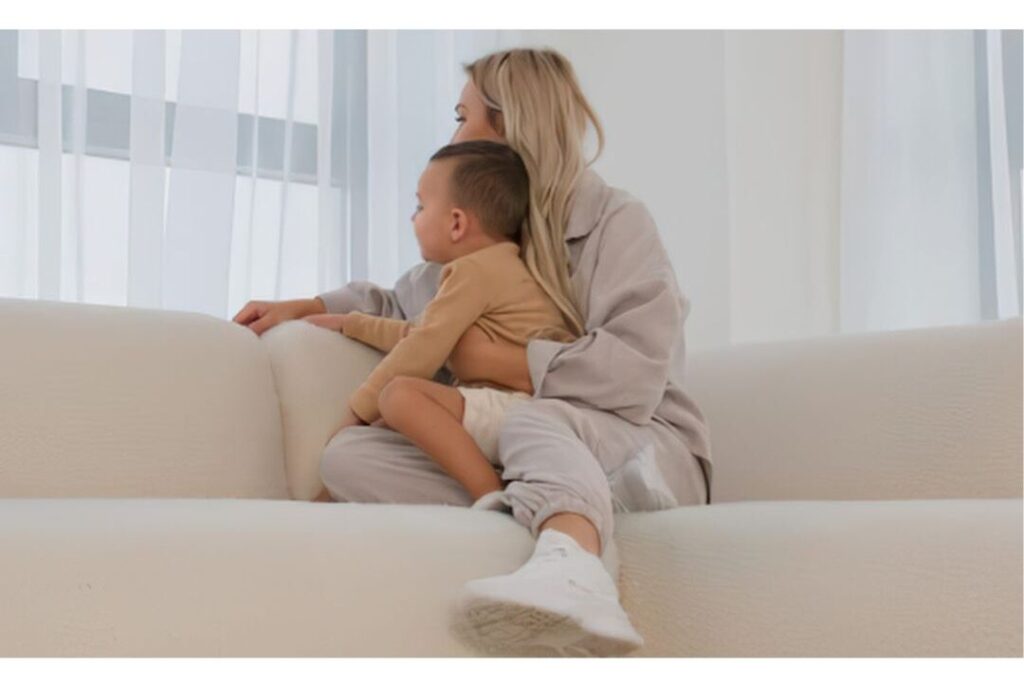 mother holding child comfortably in bright living room illustrating peaceful soft motherhood
