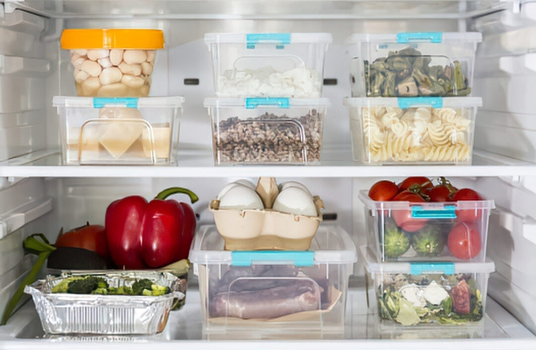 open refrigerator shelves neatly organized with clear functional storage bins