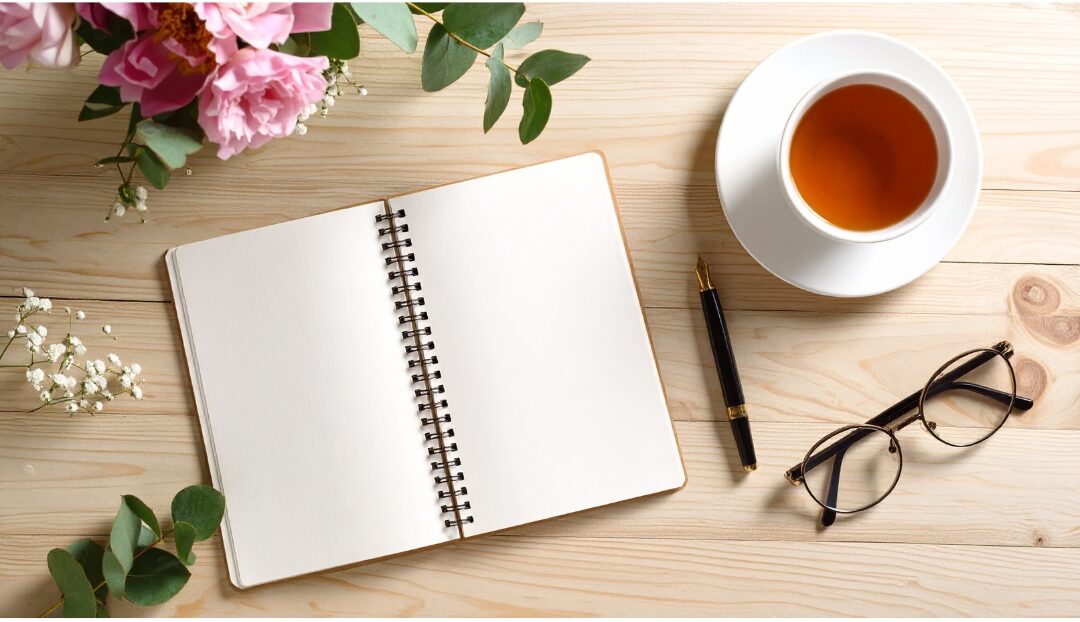 clean tidy desk with cup of tea and journal in quiet morning light establishing peaceful routines
