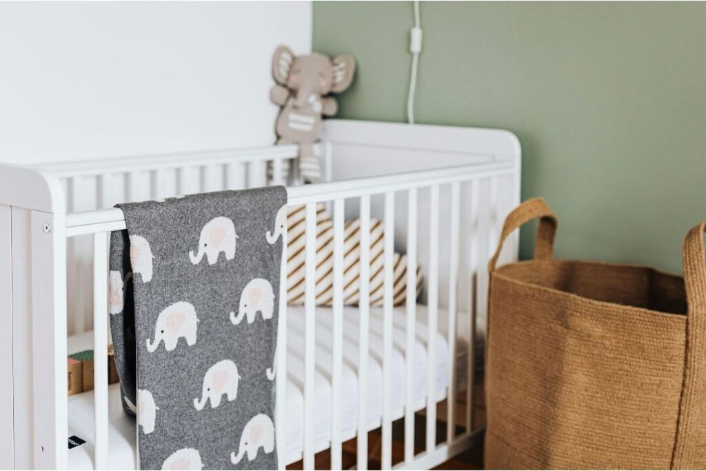 gently used baby crib demonstrating things frugal moms never waste money on