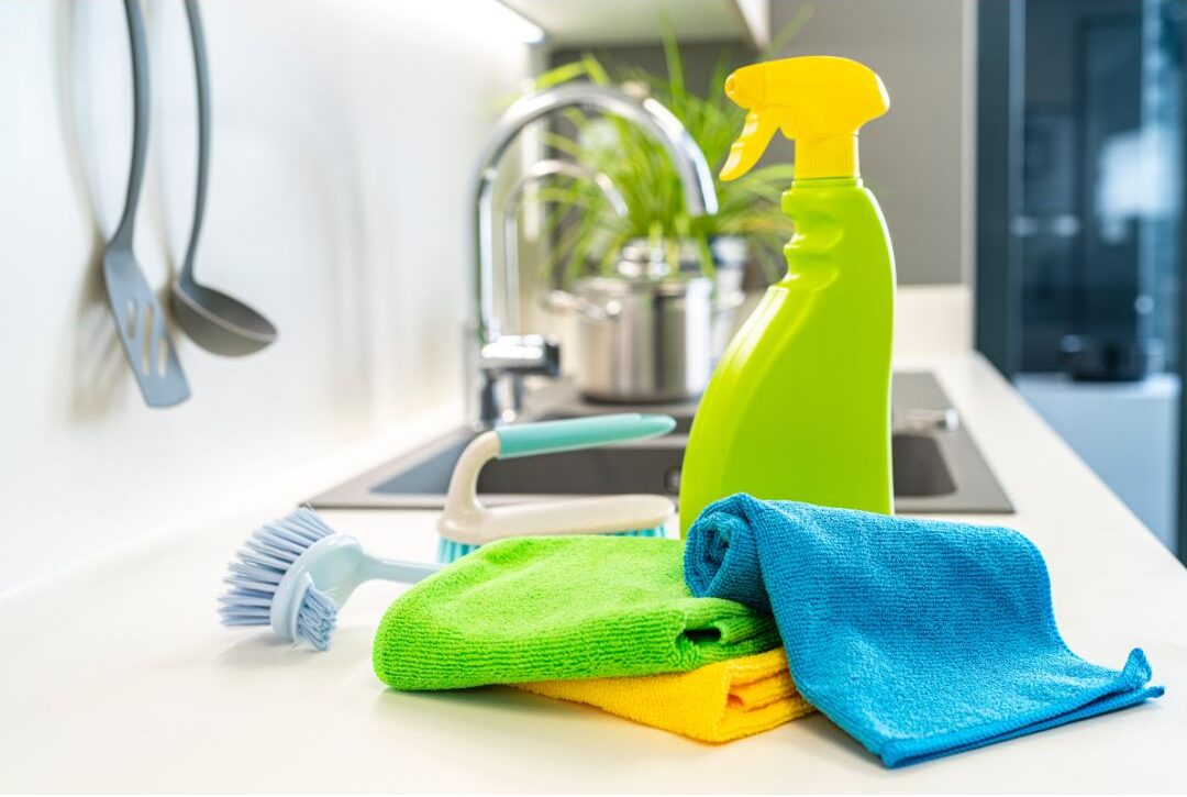 simple spray bottle and microfiber cloths on clean kitchen counter