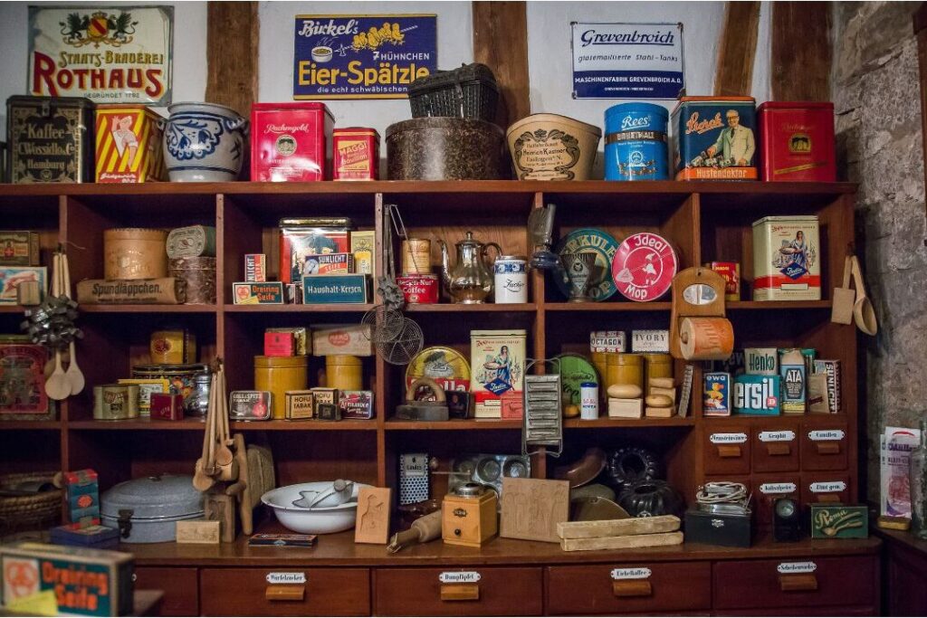 open shelf crowded with dozens of small souvenir knick-knacks