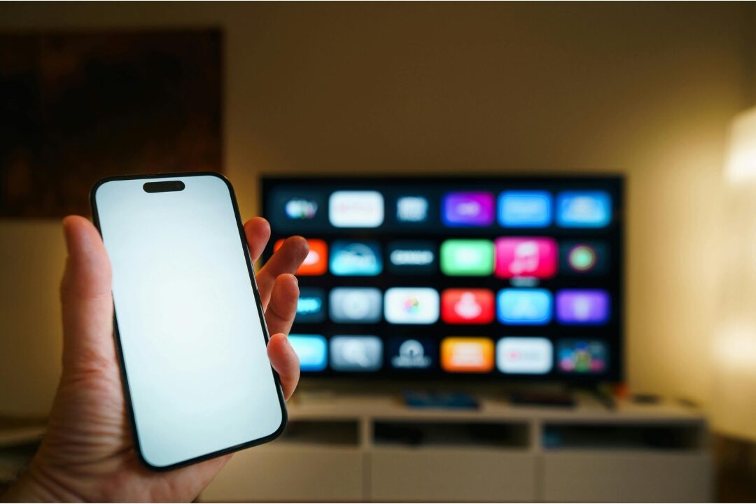 person holding a smartphone reviewing subscription settings screen