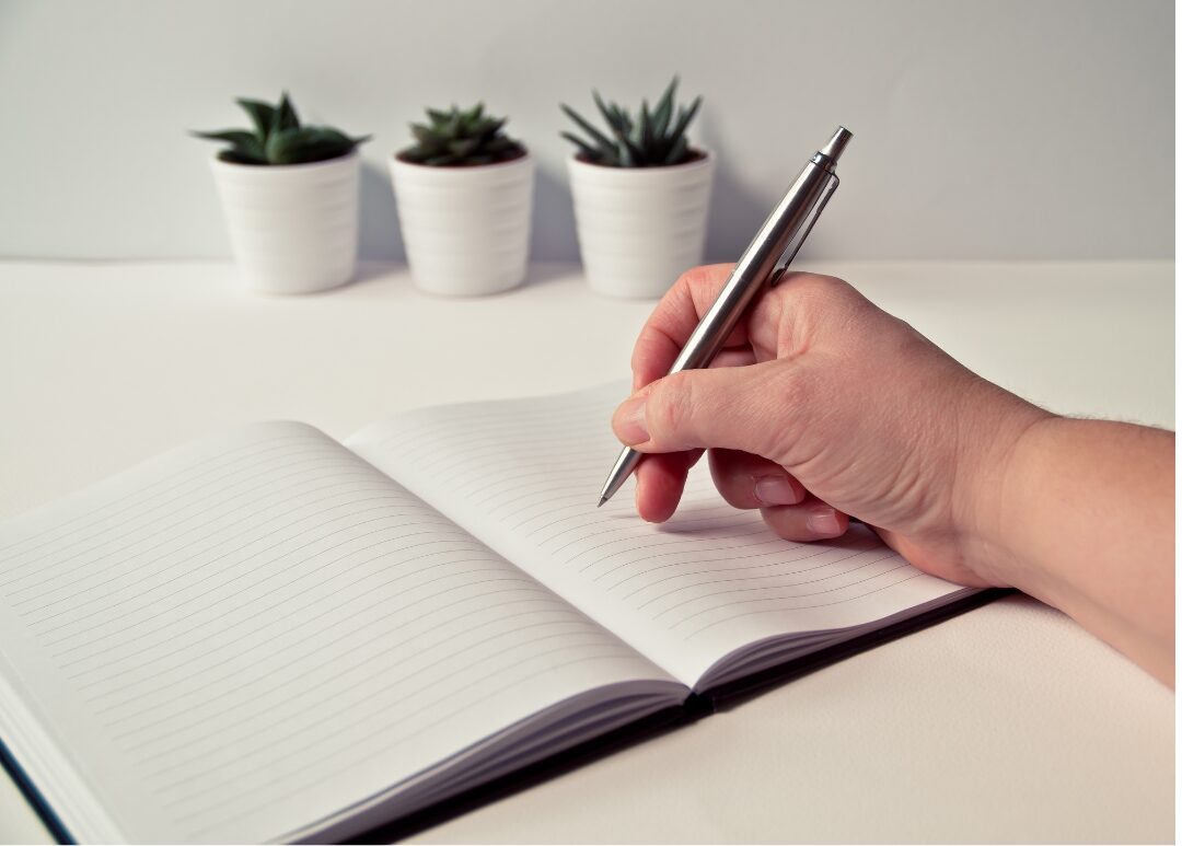 sleek pen writing smoothly on clean white notebook page showcasing 30 tiny luxuries every woman deserves