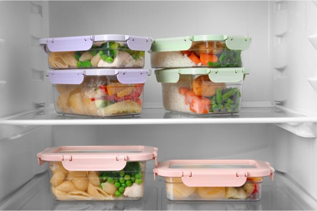 organized glass containers filled with prepped fresh vegetables in refrigerator illustrating how this one weekly habit eliminated so much stress