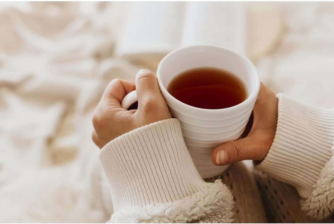 steaming hot tea mug sweater hands