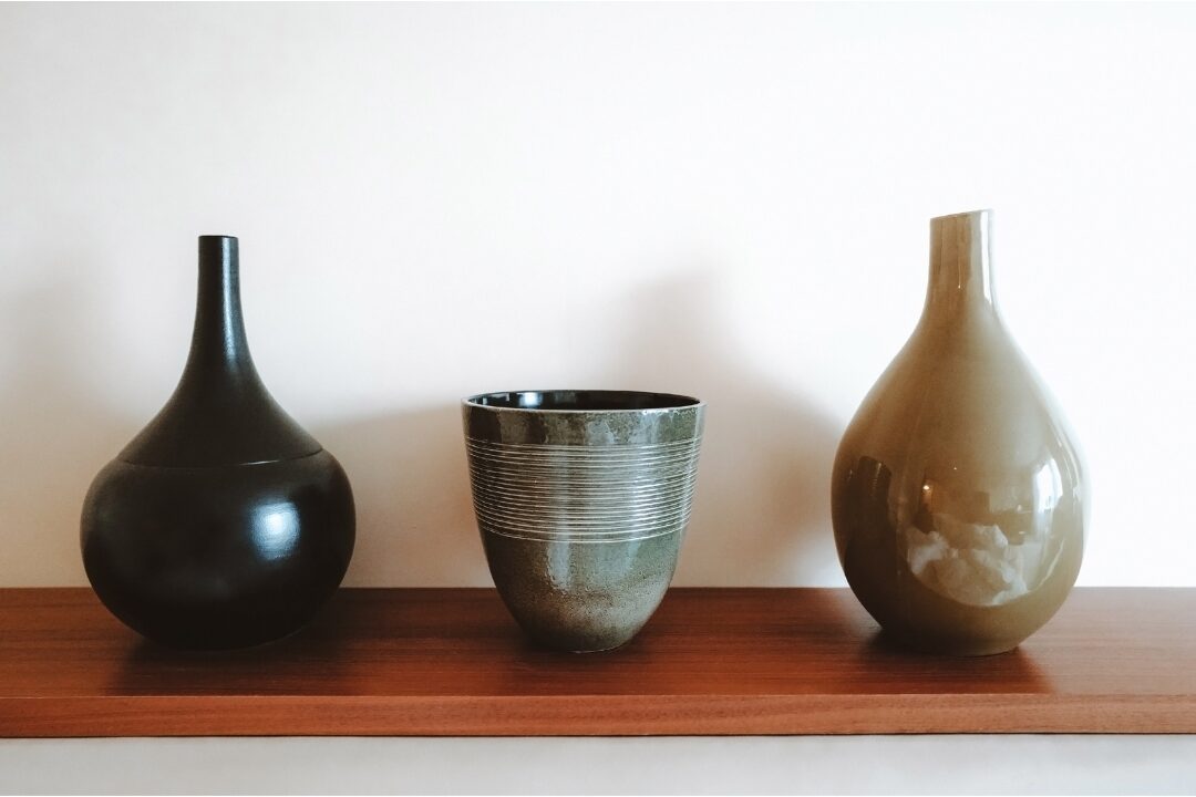 stoneware pottery vase on wooden shelf