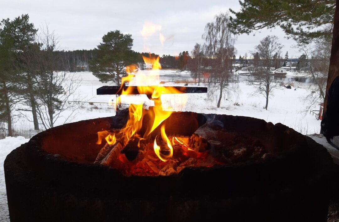 modern bioethanol tabletop fireplace burning softly on outdoor wooden table