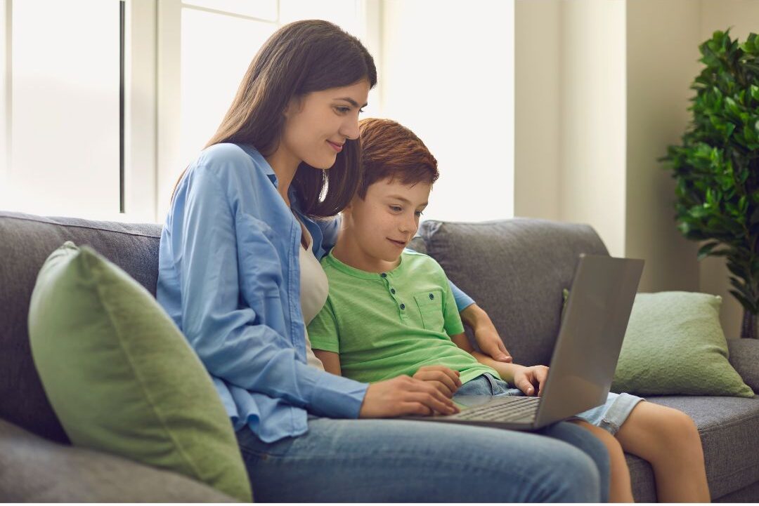parent sitting with young child opening a savings account online