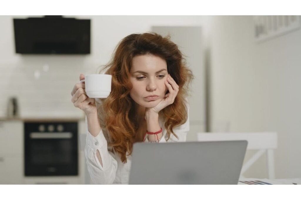 mother sitting peacefully with notebook and tea reflecting on the best budget rule nobody talks about