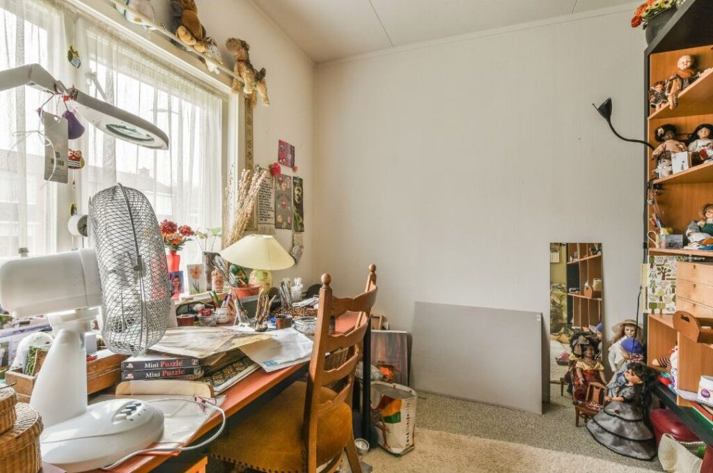 modern living room with cluttered open wooden shelving unit highlighting the one shelf that makes every house look messy