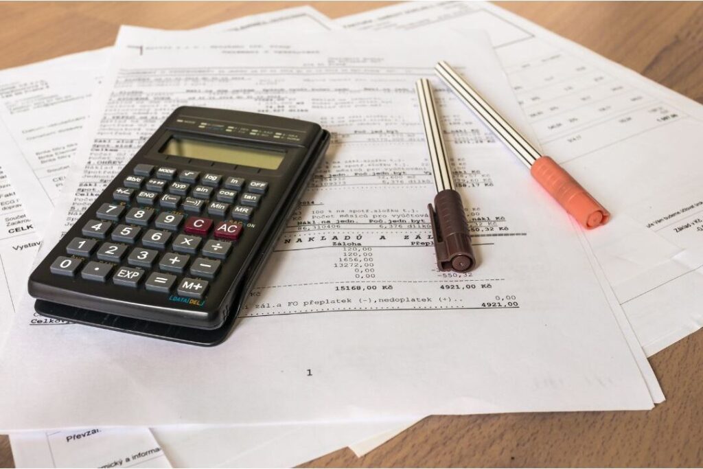 bank statements and calculator showing 30 day financial reset plan if you never have money left over read this