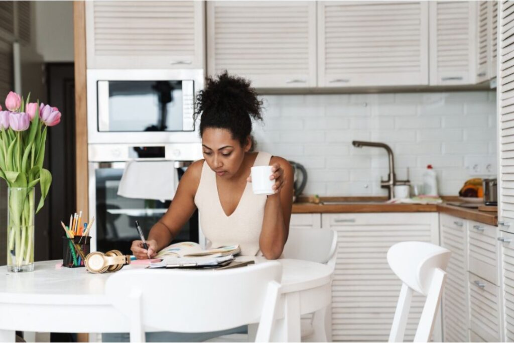 mother writing in planner running 30 day trial of the best budget rule nobody talks about