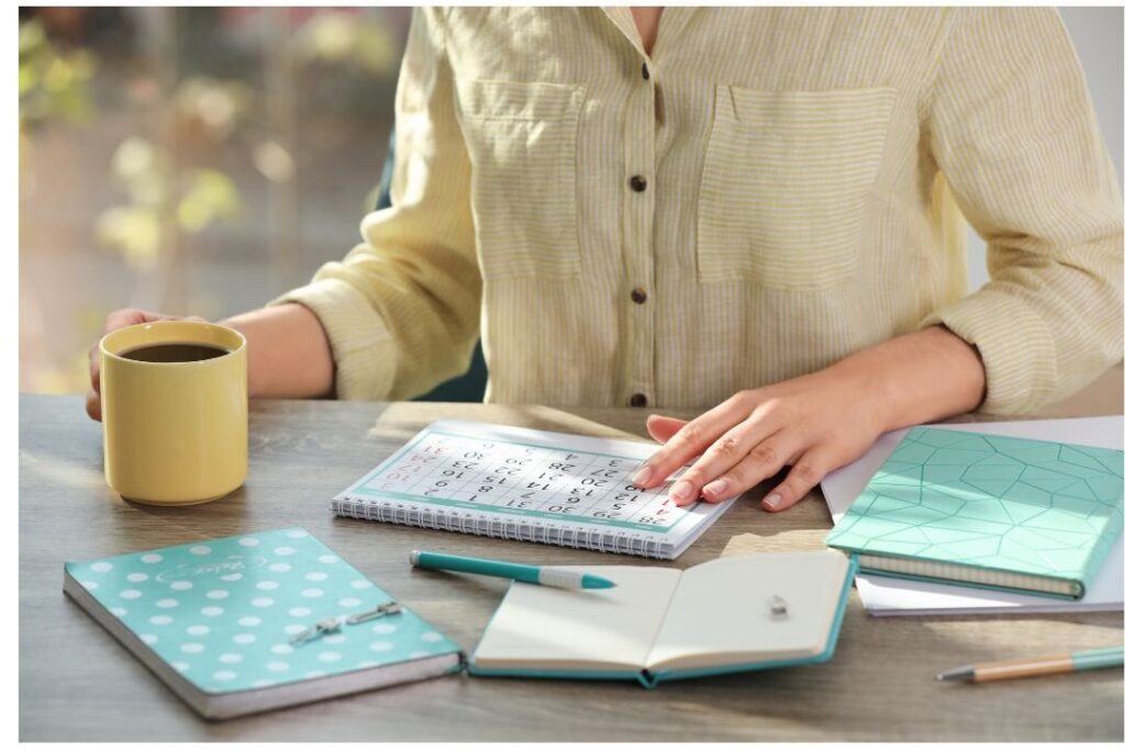 peaceful woman sitting at organized wooden desk planning week showing how this one weekly habit eliminated so much stress