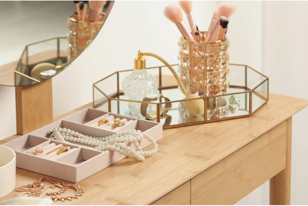 tidy vanity table with a wooden jewelry box and small mirror