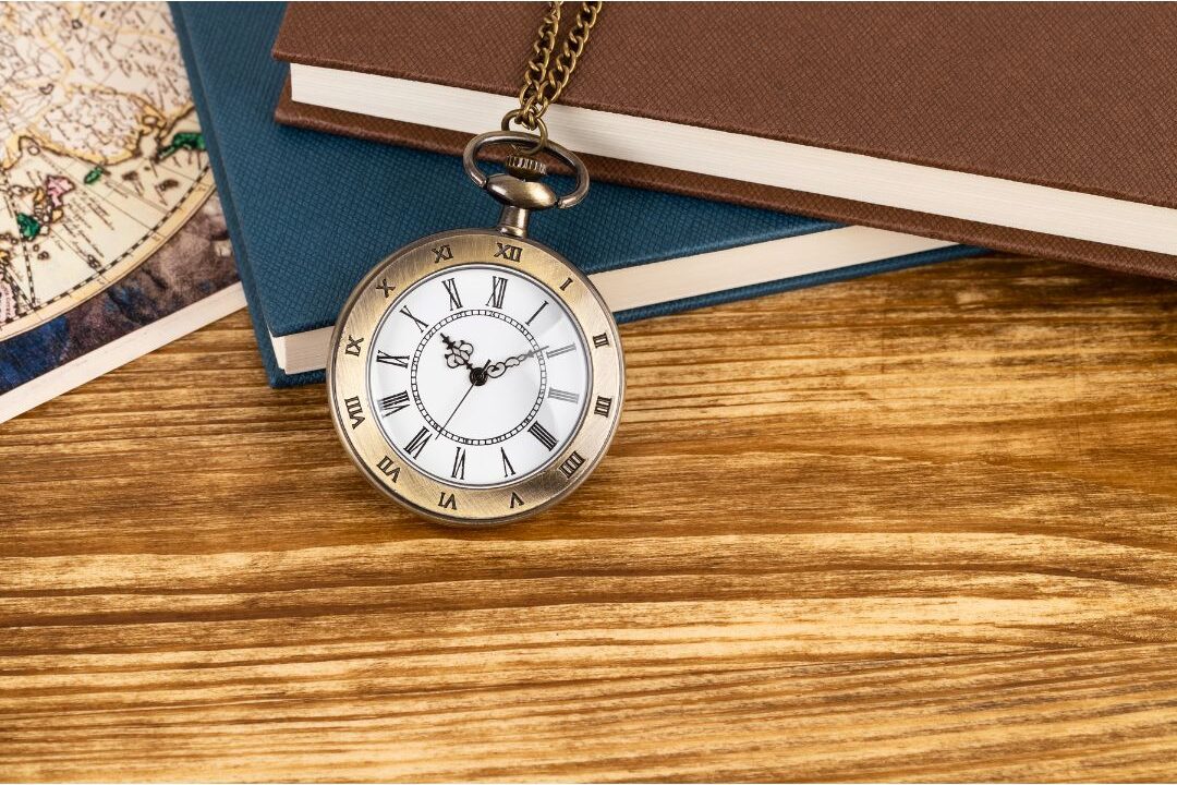 minimalist vintage watch resting on wooden desk with journal