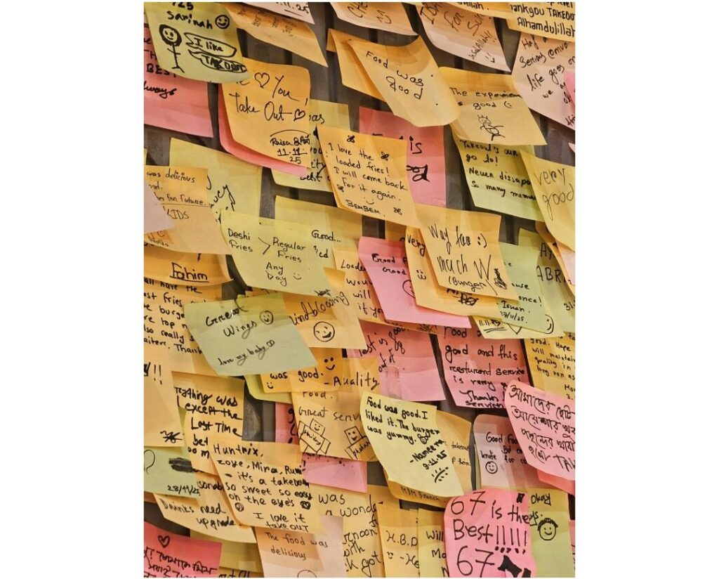 shelf with taped sticky notes and loose unframed paper reminders