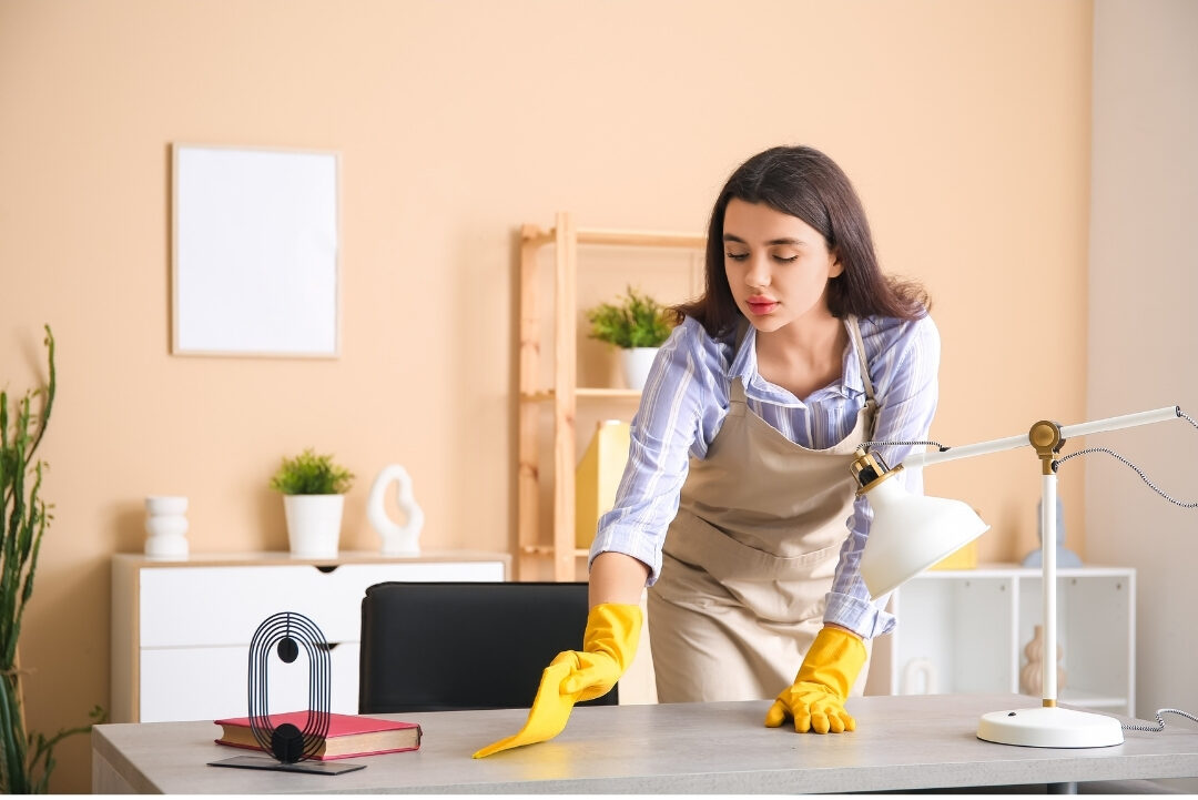 woman working at clean wooden desk while keeping living space tidy managing home distractions