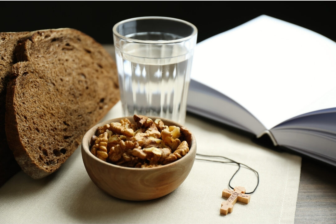 glass water bottle and healthy bowl of nuts sitting on modern desk overcoming the biggest distractions in every home office