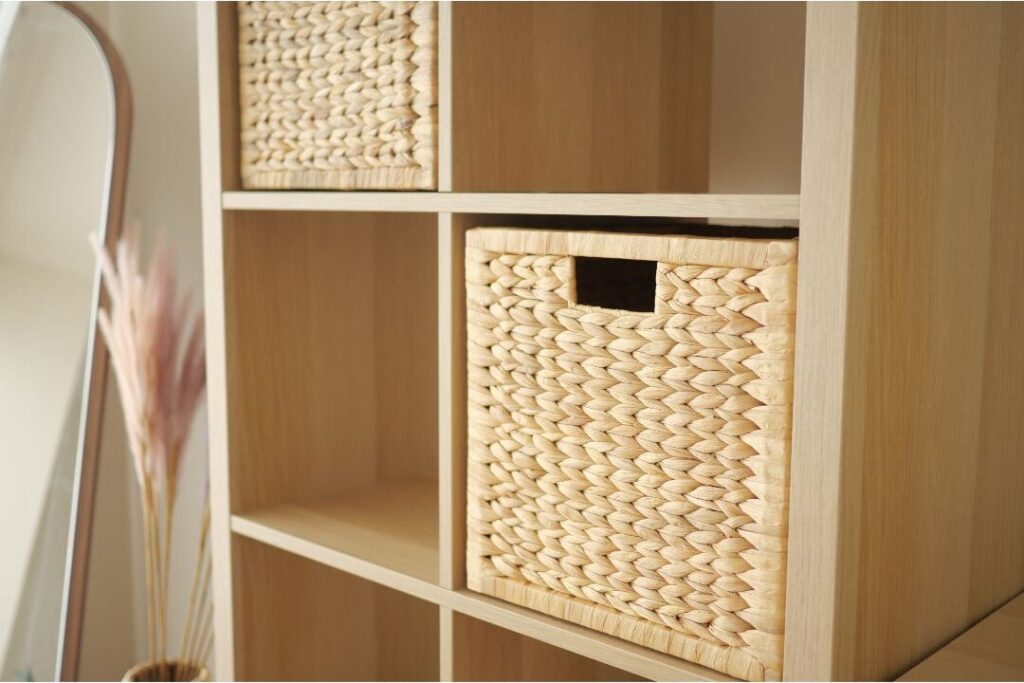 neat woven storage baskets sitting symmetrically on wooden shelf