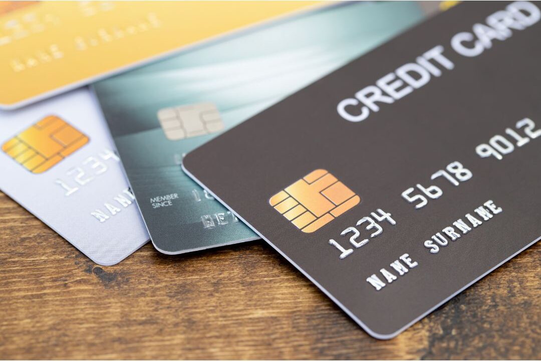 black credit card resting flat on minimalist dark marble surface