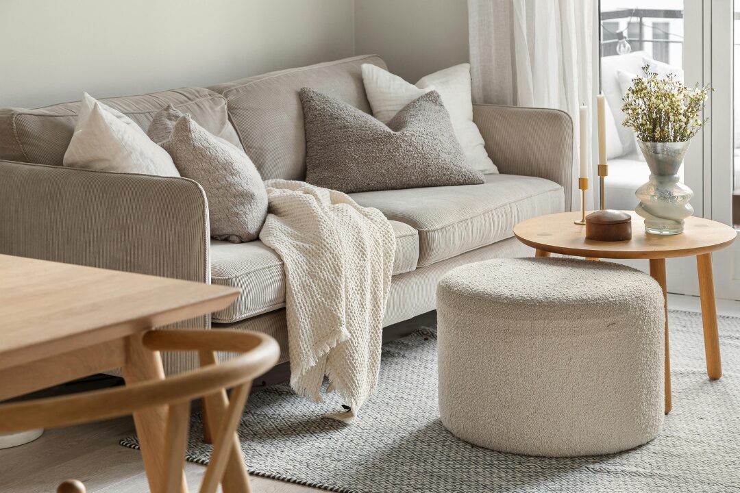 warm natural oak side table beside soft linen sofa in sunny living room presenting 40 cozy home ideas you'll want to copy