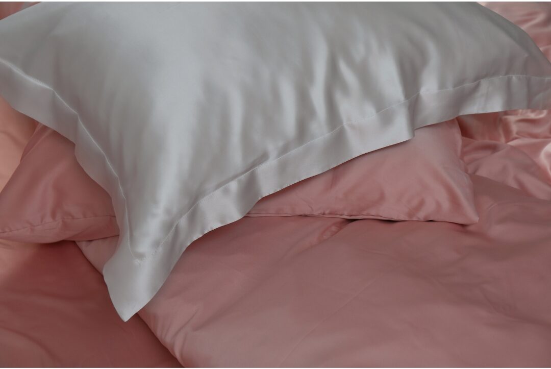 satin weighted eye pillow filled with lavender resting on soft linen