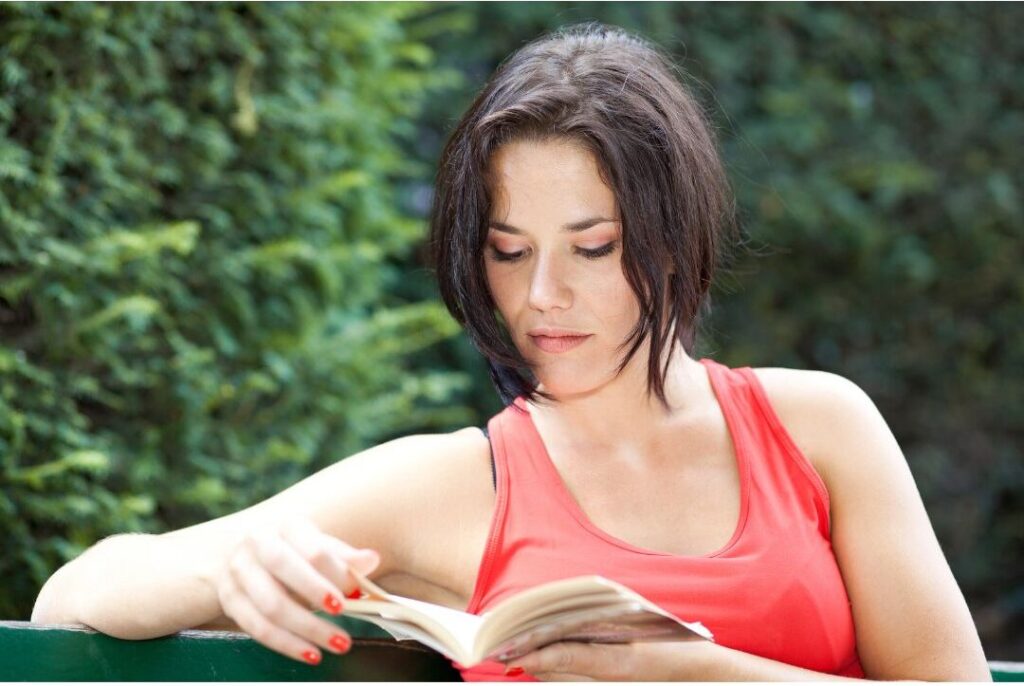 woman reading book outdoors reflecting identity preservation in the soft life checklist i wish every mom had before having kids