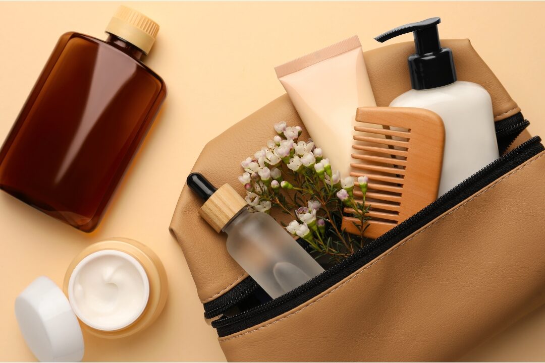 wooden wide tooth comb beside clear travel toiletry pouch working through 50 things to stop buying to save money
