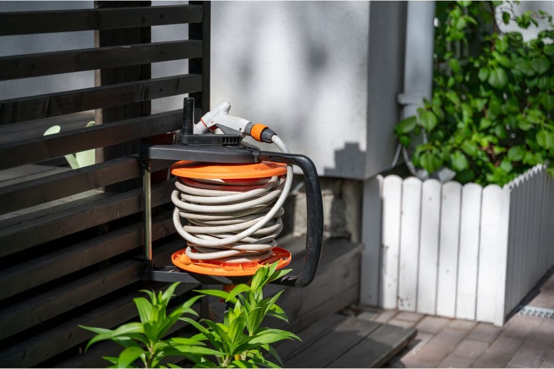 wooden decorative hose reel box hiding garden hose outside