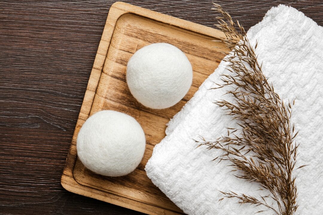 wool dryer balls in laundry basket discovering 50 things to stop buying to save money