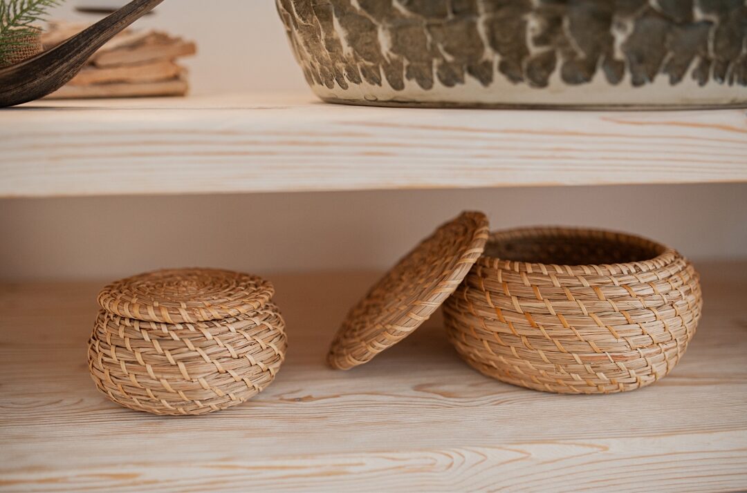 woven rattan storage basket with lid sitting neatly in a room corner