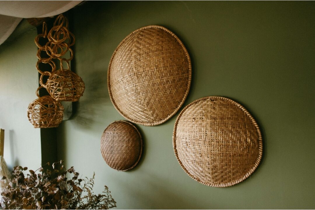 round woven seagrass wall baskets arranged artfully on bedroom wall highlighting 40 cozy home ideas you'll want to copy