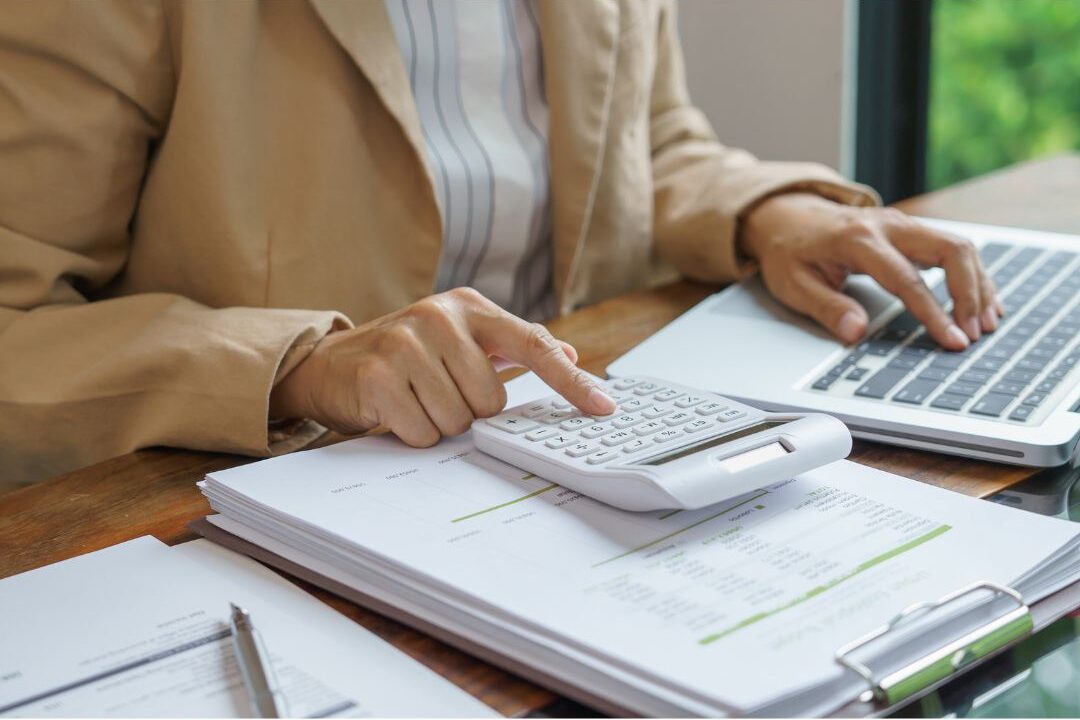 young adult analyzing financial investment reports at clean desk